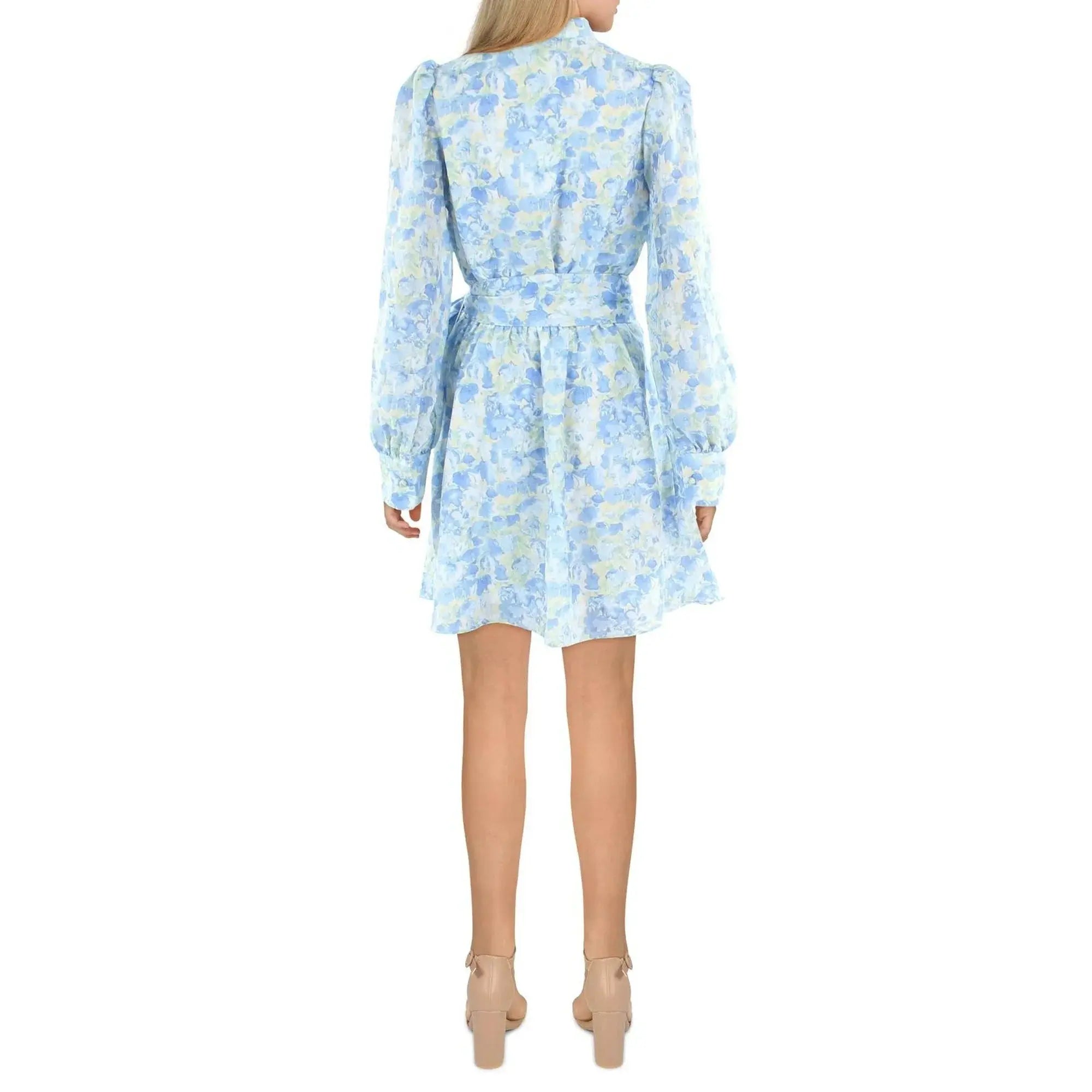Woman wearing a light blue floral dress on a white background