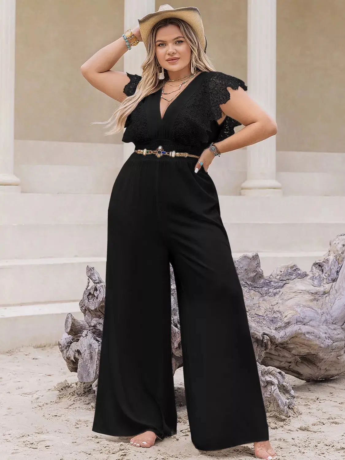 Woman wearing a plus-size lace cap sleeve wide leg jumpsuit from Vicsxox