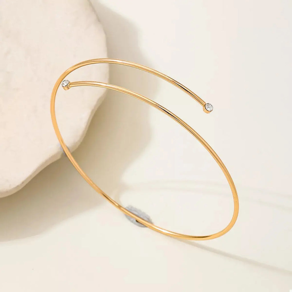 Close-up of gold wire detail on arm bracelet