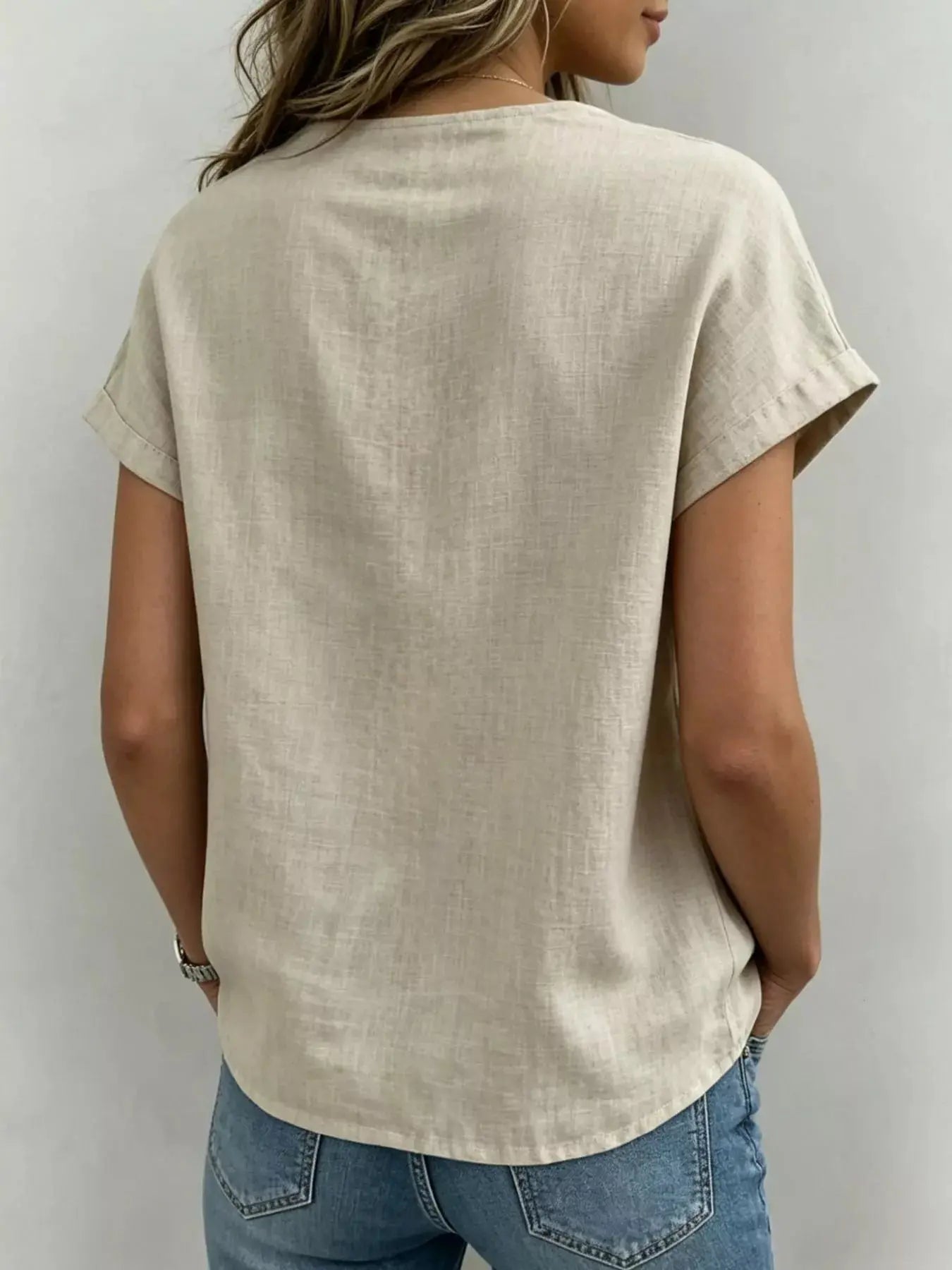 Close-up of tied bow neckline detail on plus-size blouse