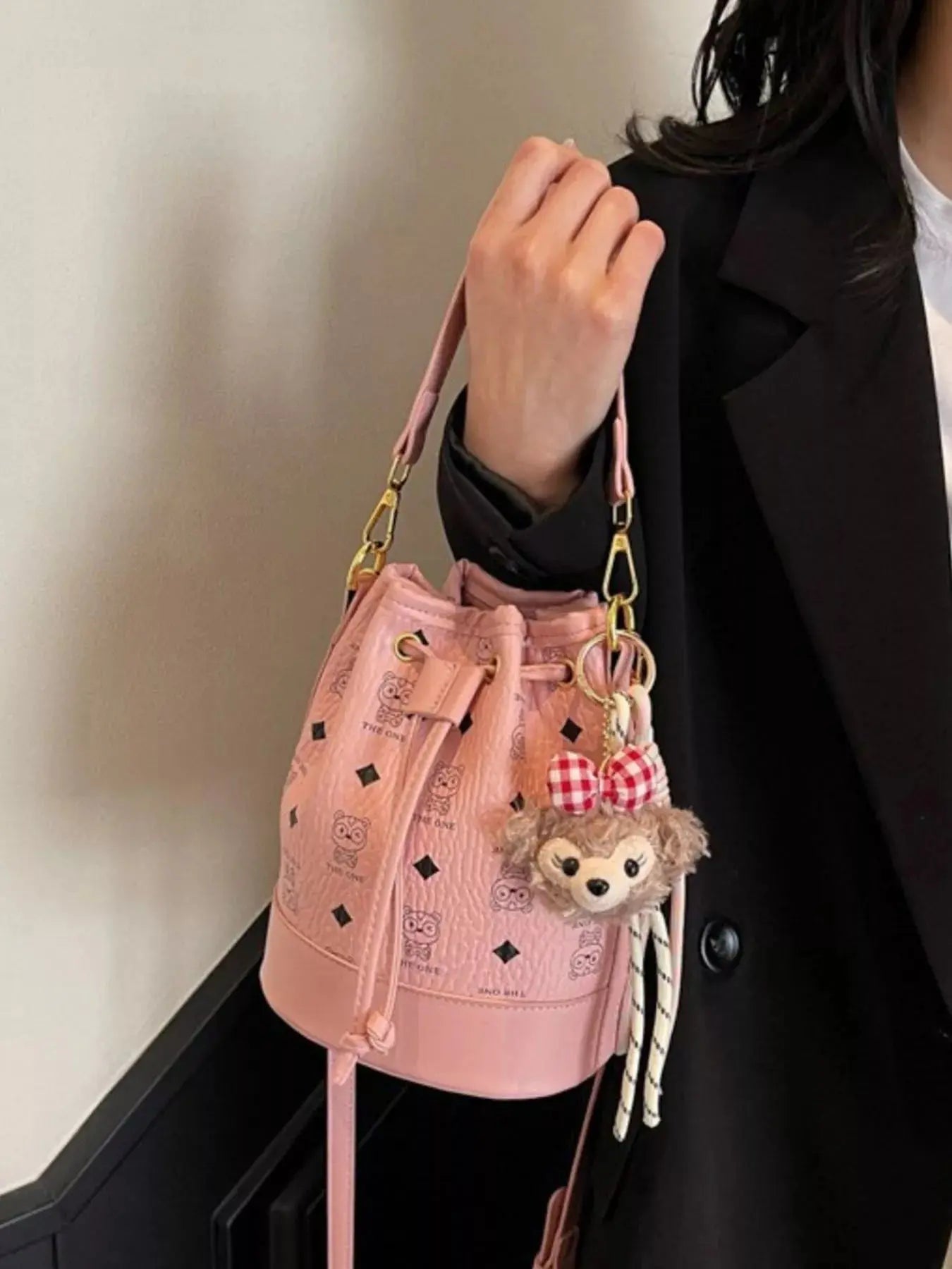 Mini drawstring bucket crossbody bag styled on model