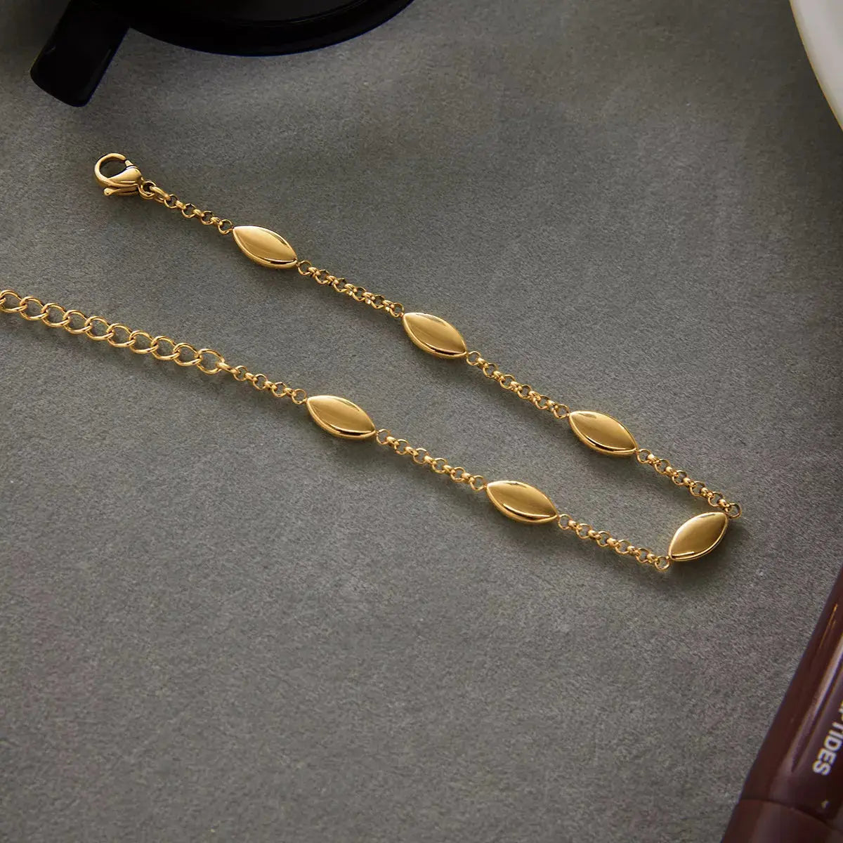 Woman wearing gold chain link bracelet
