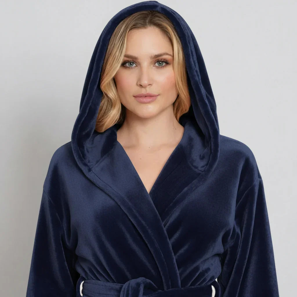 Woman wearing a navy blue hooded robe against a plain background. Vicsxox.com