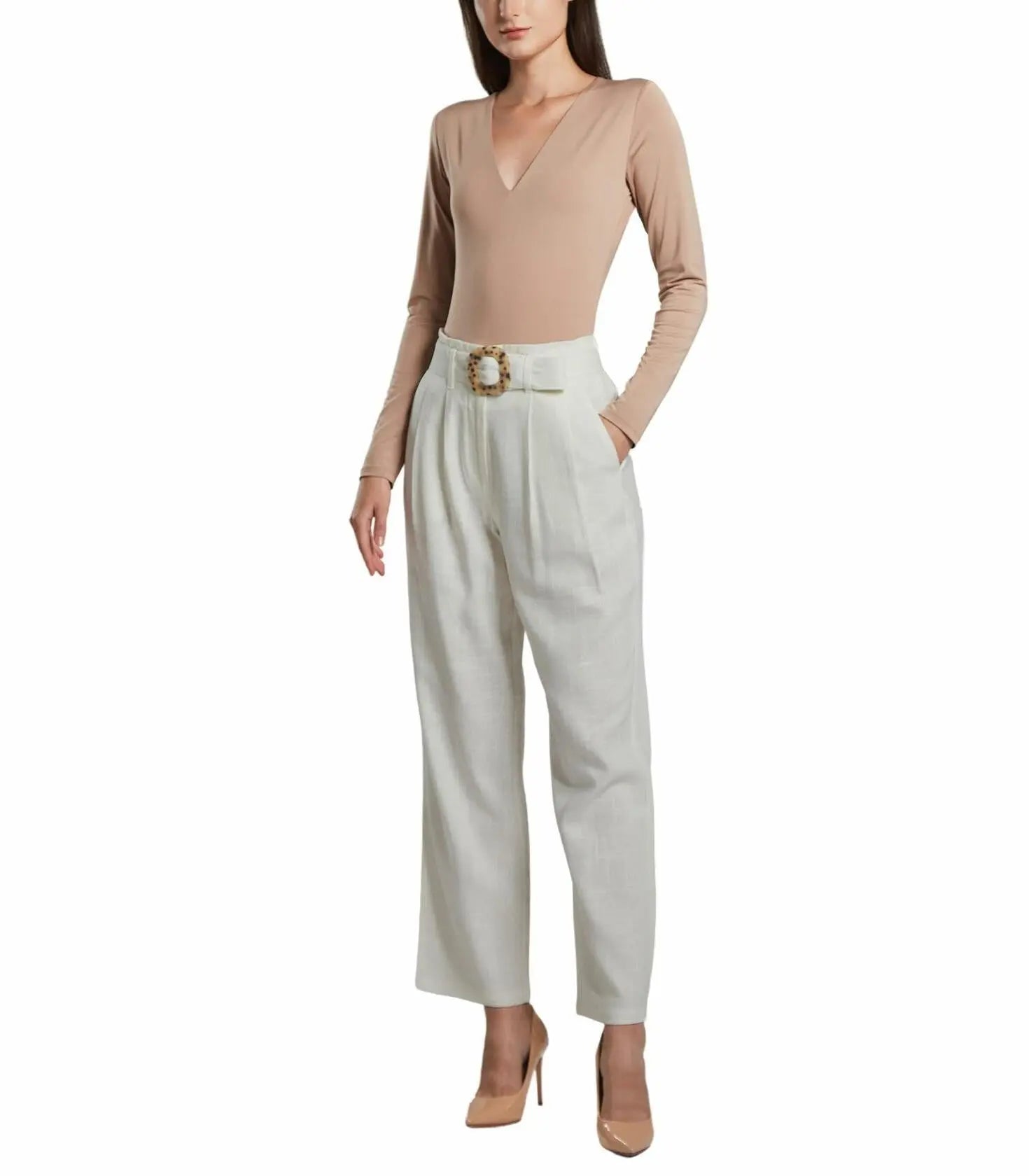 Woman wearing a beige bodysuit and white pants with a belt on a white background