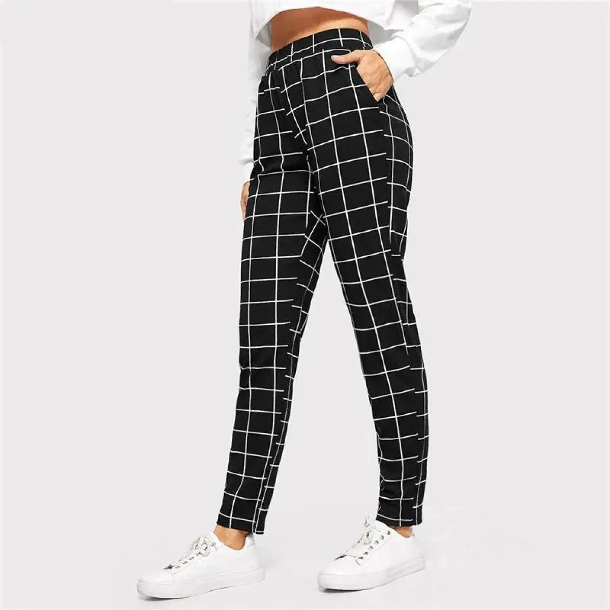 Black and white checkered pants worn by a person on a white background