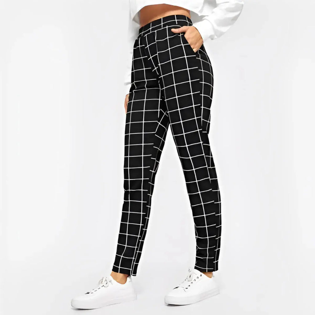 Black and white checkered pants worn by a person on a white background