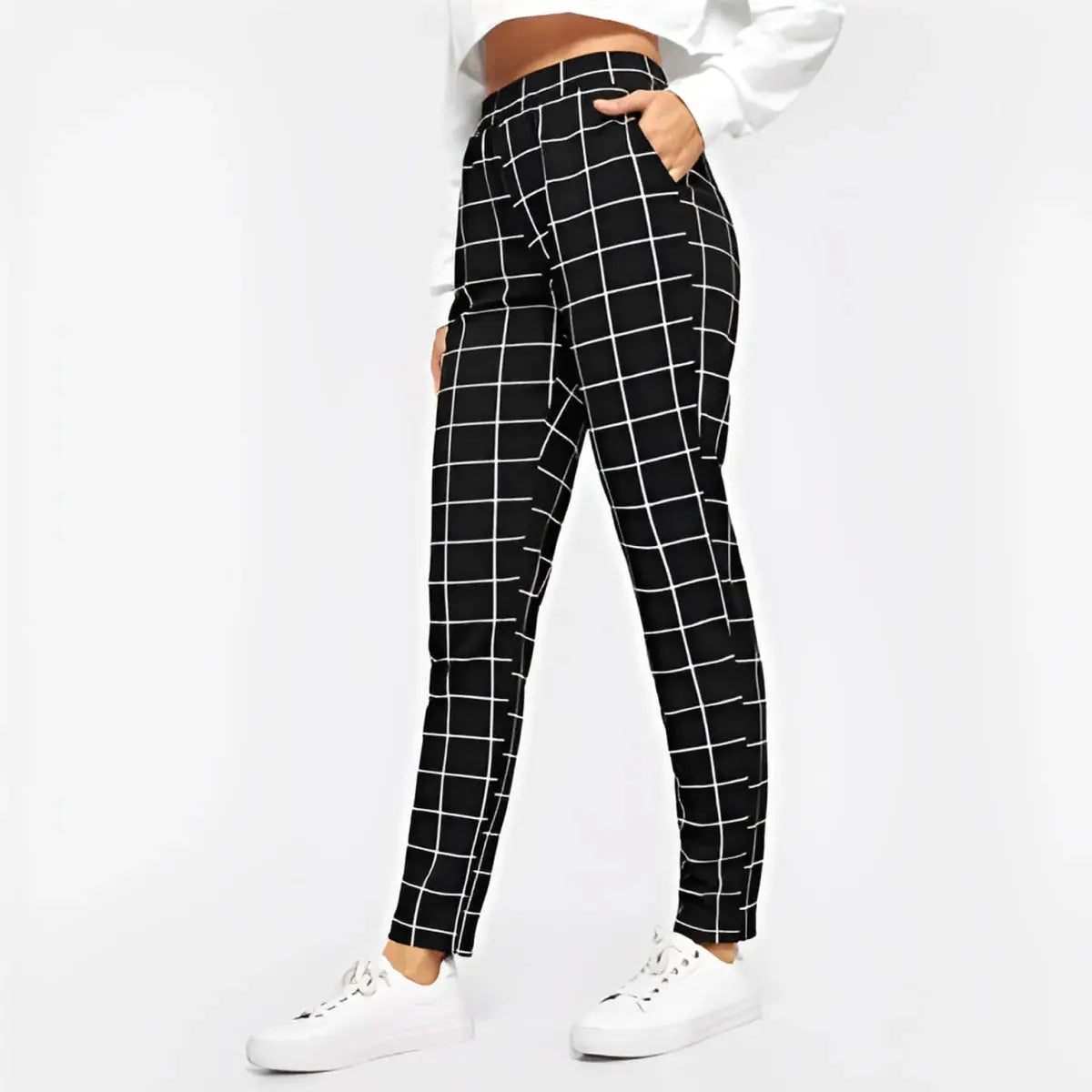 Black and white checkered pants worn by a person on a white background
