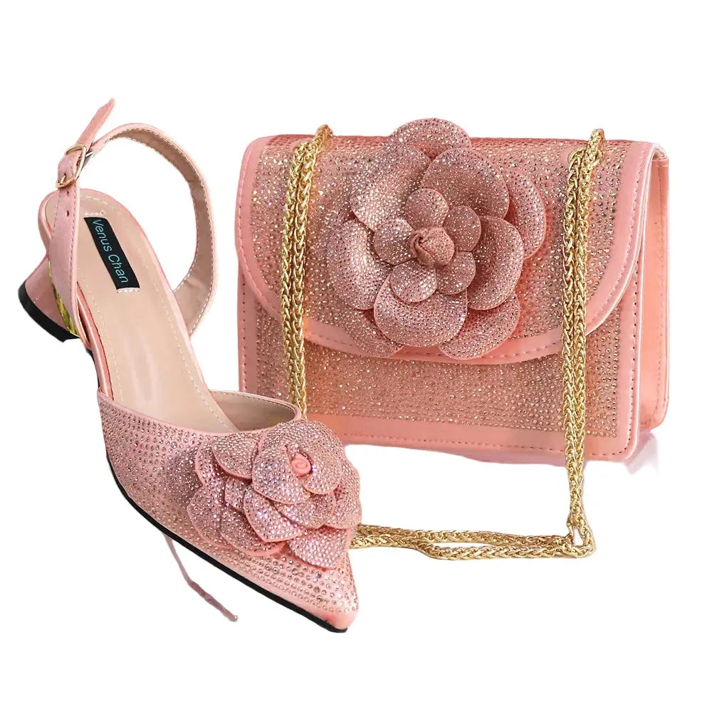 Pink high-heeled shoes and matching handbag with floral design on a white background