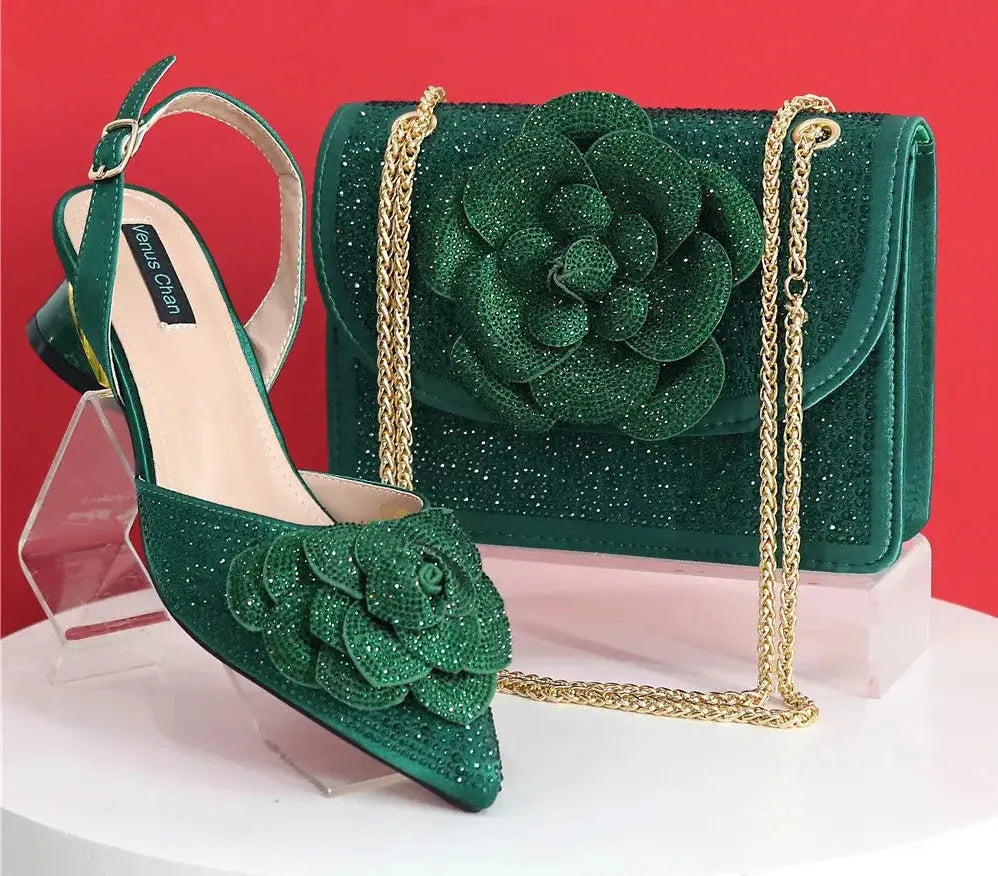 Green high-heeled shoes and matching handbag with floral design on a white background