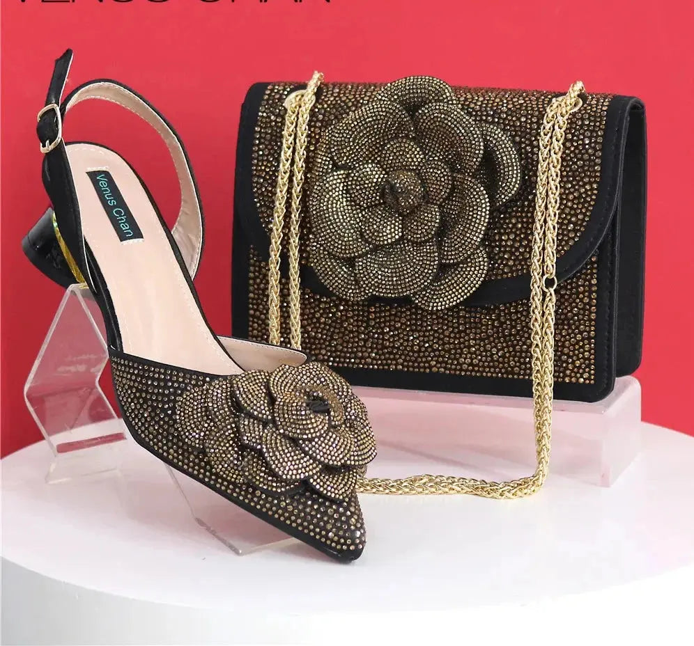 black high-heeled shoes and matching handbag with floral design on a white background