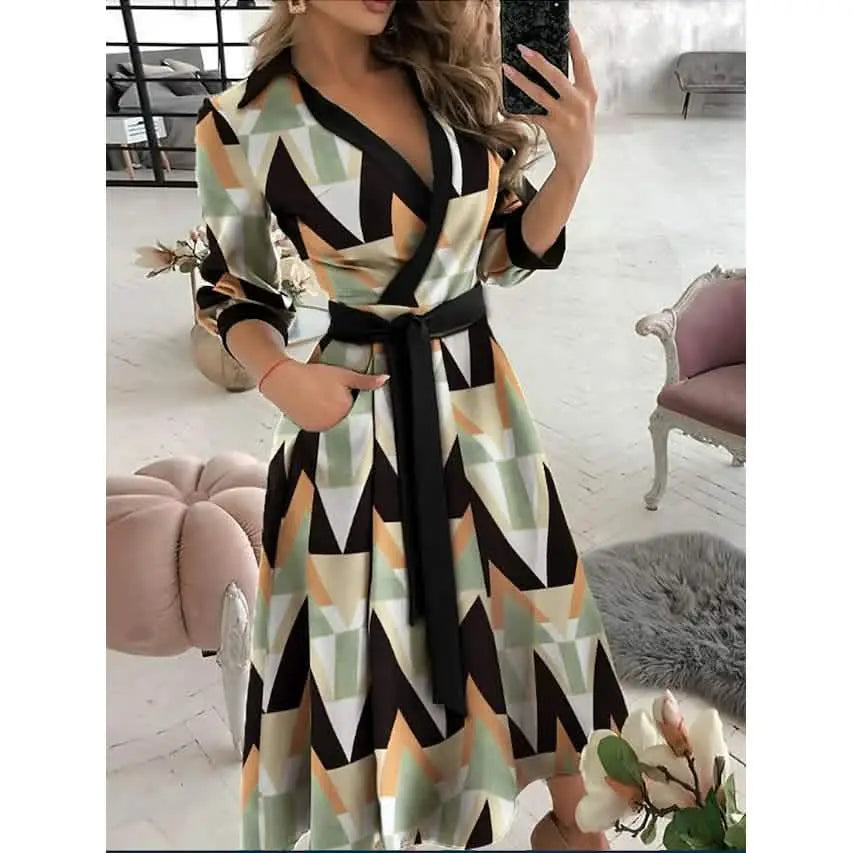 Woman wearing a geometric patterned dress in a room with furniture.