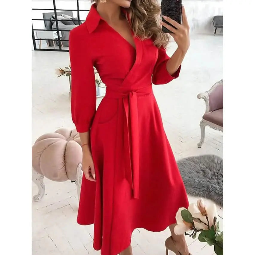 Woman wearing a red dress in a bright room with furniture.