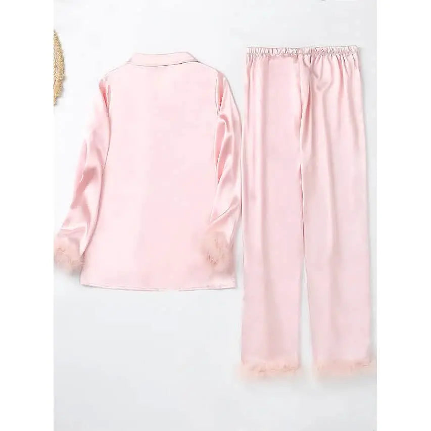 Pink pajama set with lace trim on a white background